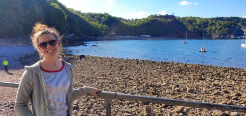 Women posing next to beach