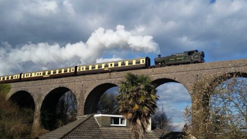 Steam train, clouds, viaduct, house, palm tree