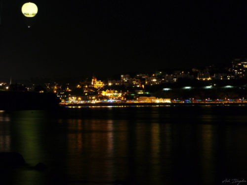 A balloon over a body of water at night