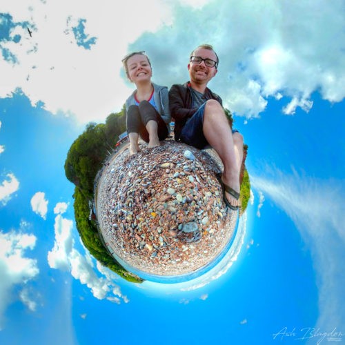 two people sat on a beach