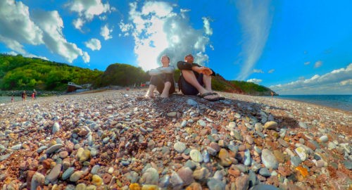 two people sat on a beach