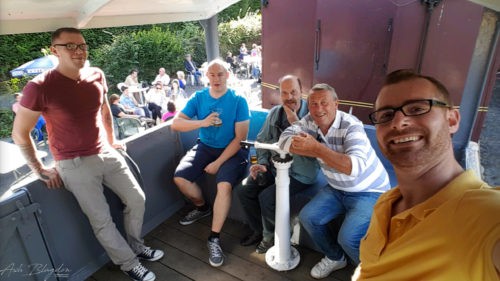 Friends enjoying a beer in a train carriage